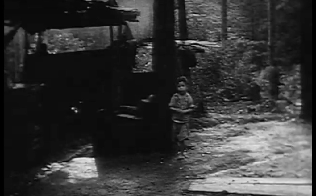 Little boy walking towards film camera - from NBN News Film AF7-AF9 circa April-May 1963.
