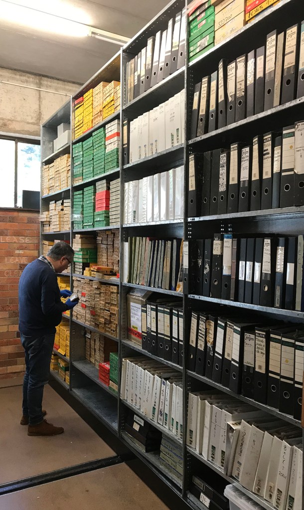 Dr Amir Moghadam, University Conservator, Examining Hannan Archive Negatives