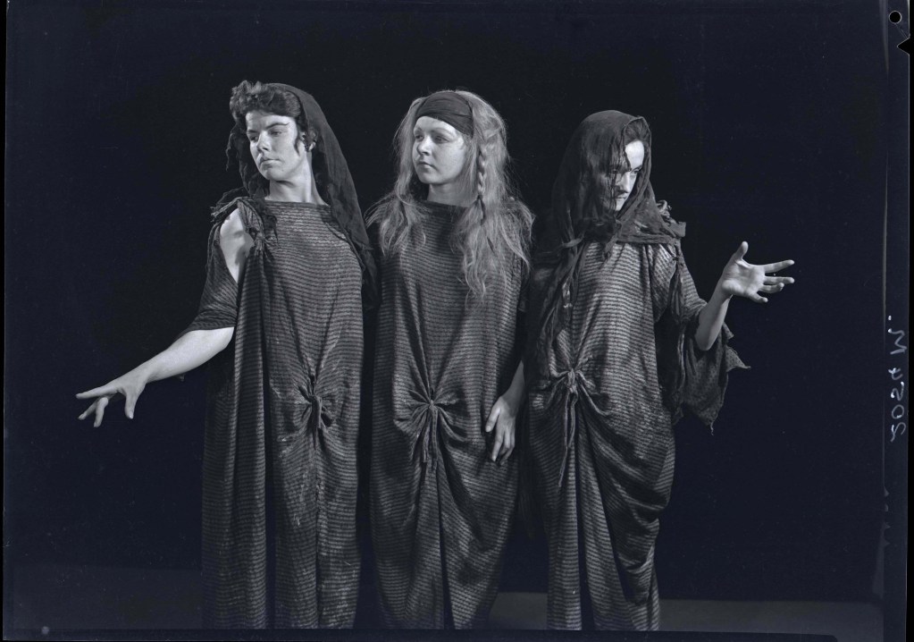 Three women in theatrical setting. Three witches in Macbeth performed at Tighes Hill (L to R - Janet Combridge, Helen Tripp, Wendy Doyle ? (possibly Joyce Williams standing in for the photo shoot). June/July, 1961. [Hannan Archive AHAN00479]