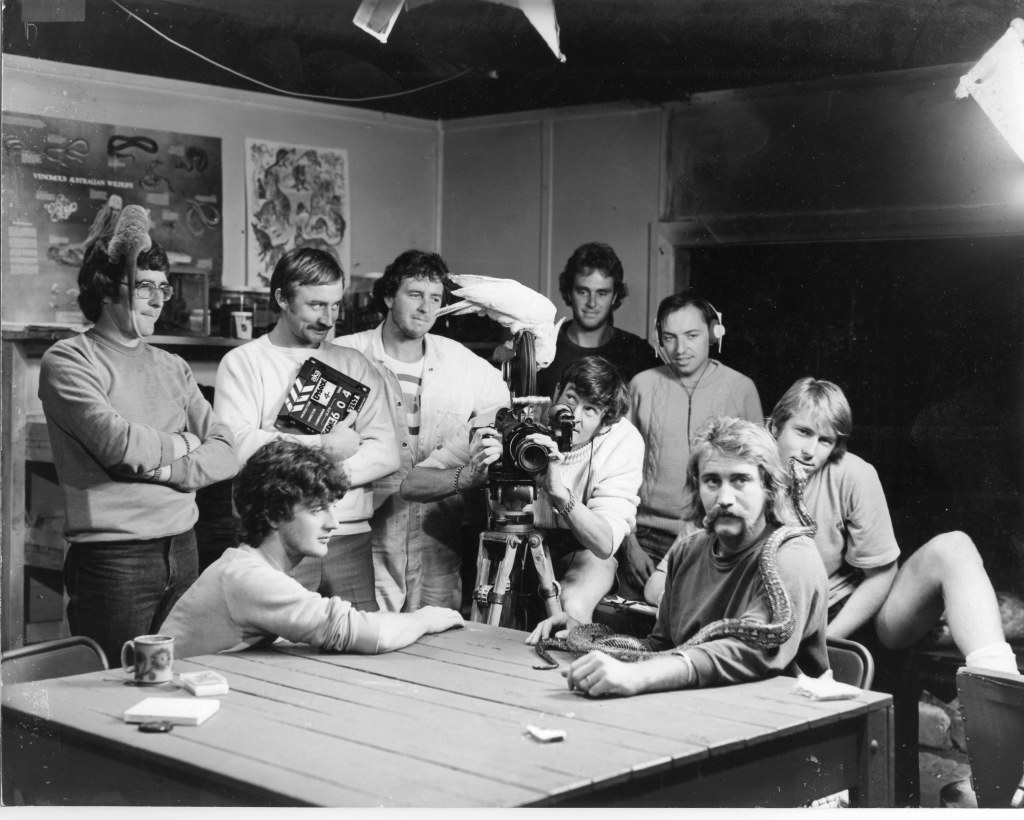 The production team of "Beating Around the Bush" 1979 (L to R) Art Ryan (with possum), Warren Cantello, Phil Lomas, Charlie Dunkley, Barry Nancarrow (with cockatoo), Greg Boswell, Joe Palmer, Ian "Beat" Hill (with serpent) and Peter Scanlon. (Courtesy NBN Archive)