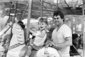 The Newcastle Show. Emma from Maryland rides the oldest Merry-Go-Round with Dad. 23 February 1984. Photographer: Quentin Jones.