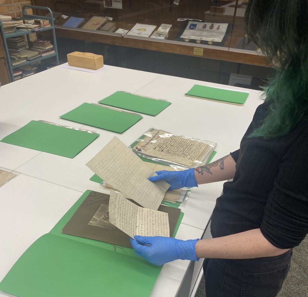 Erica Wright (Vera Deacon Intern) in Special Collections rehousing archival letters (May 2025)